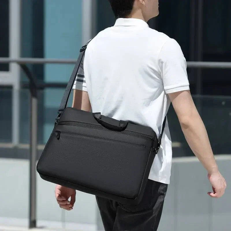 Elegant black business laptop bag for commuters, fits 15.6–17.3 inch laptops, adjustable shoulder strap.